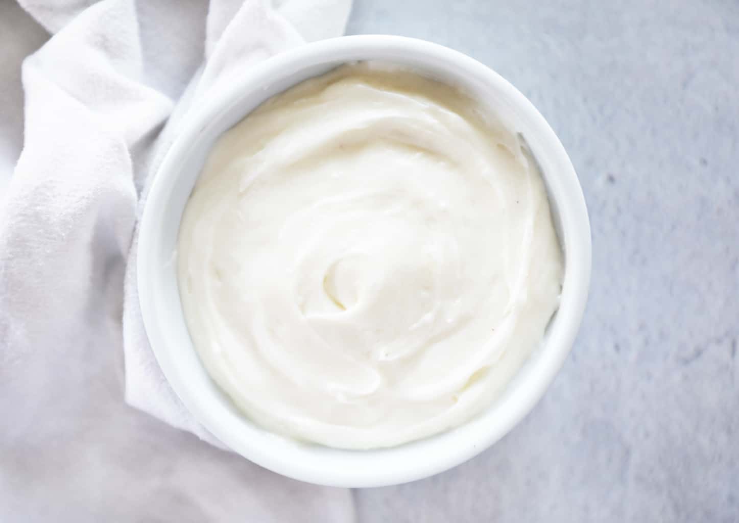 birds eye view of cream cheese frosting next to a white cloth