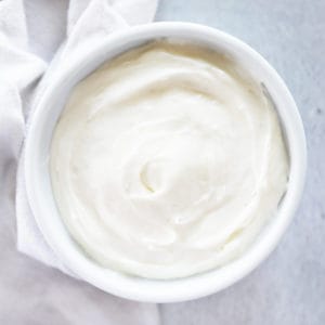 homemade cream cheese frosting in a small white dish