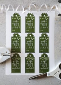 free printable gift tags next to scissors, ribbon and a hole punch