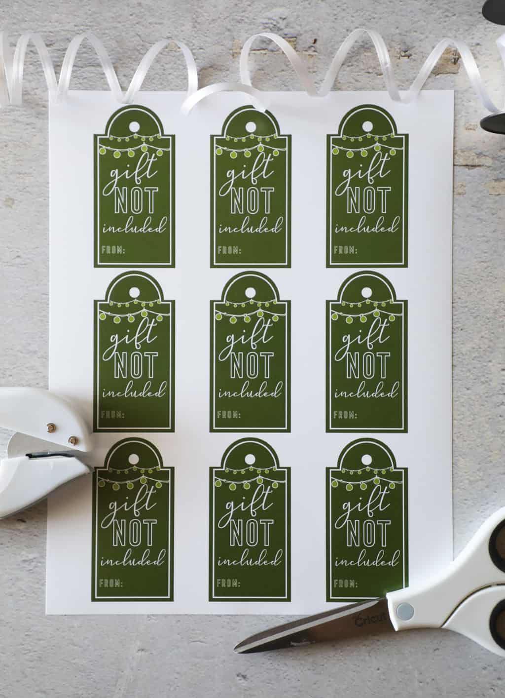 free printable gift tags next to scissors, ribbon and a hole punch