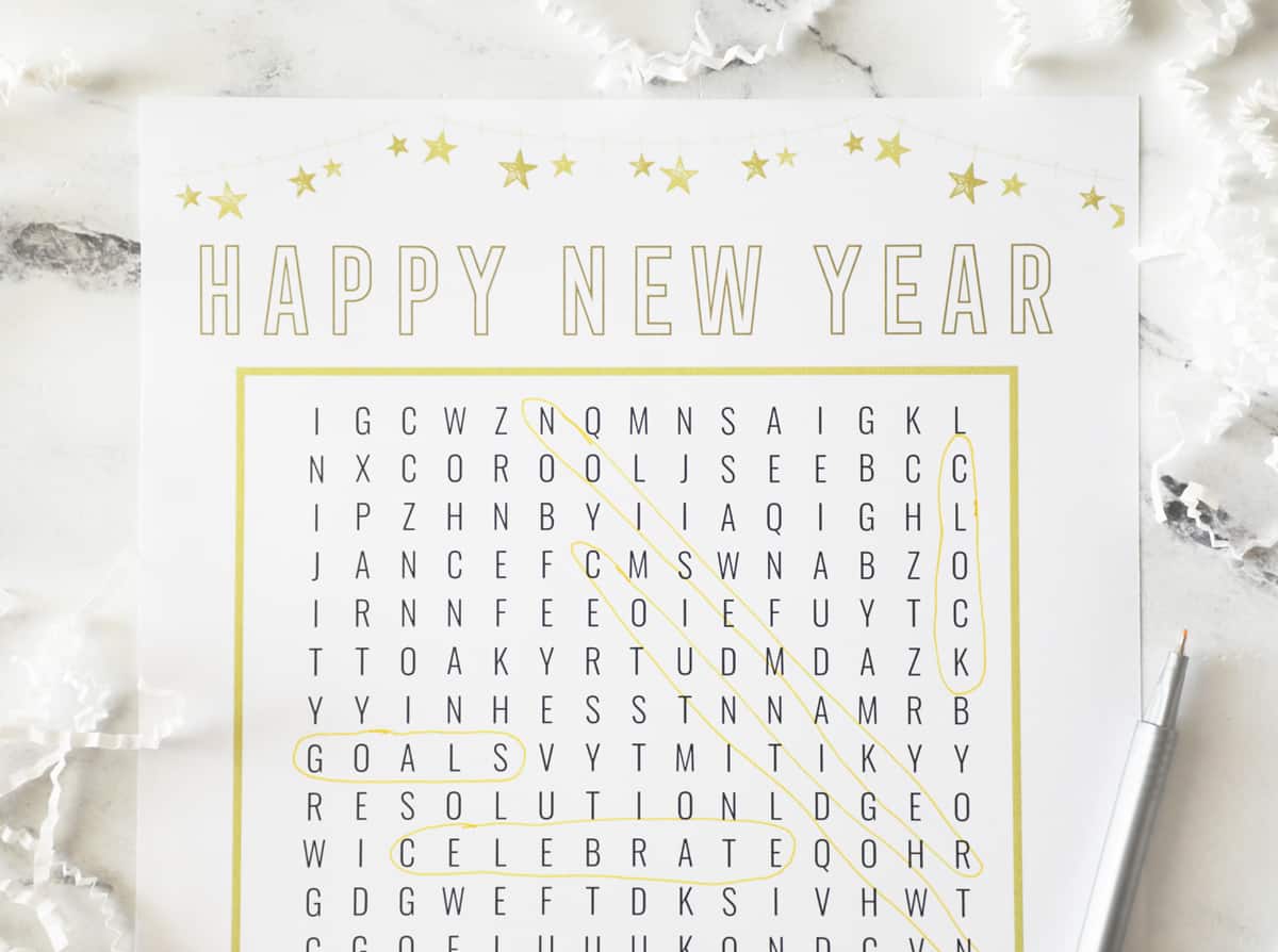 gold and white nye word search with words circled in gold pen