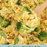 Slow cooker chicken and rice with melty cheese and broccoli being scooped with a serving spoon