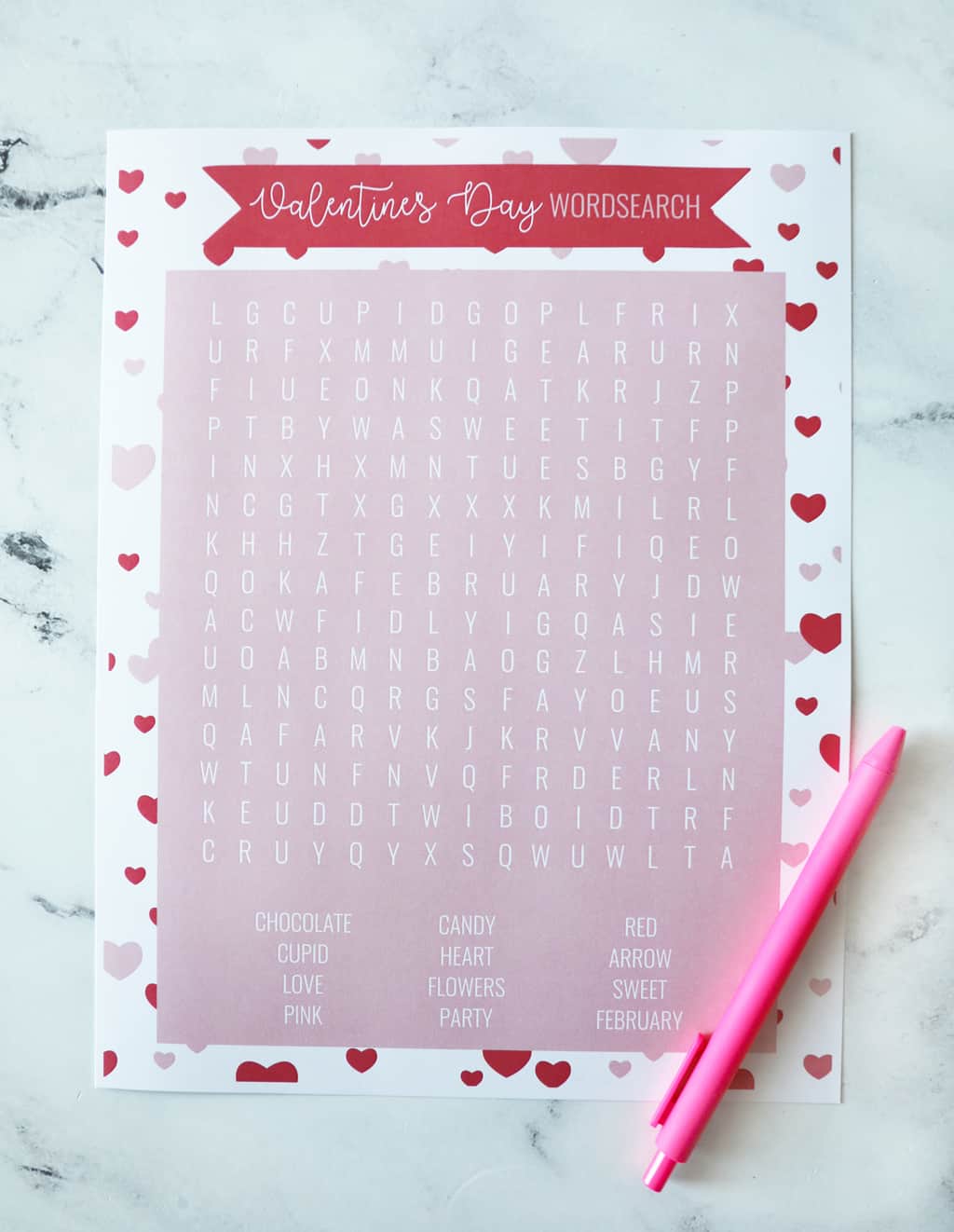 blank Valentine's Day word search on countertop with pink pen