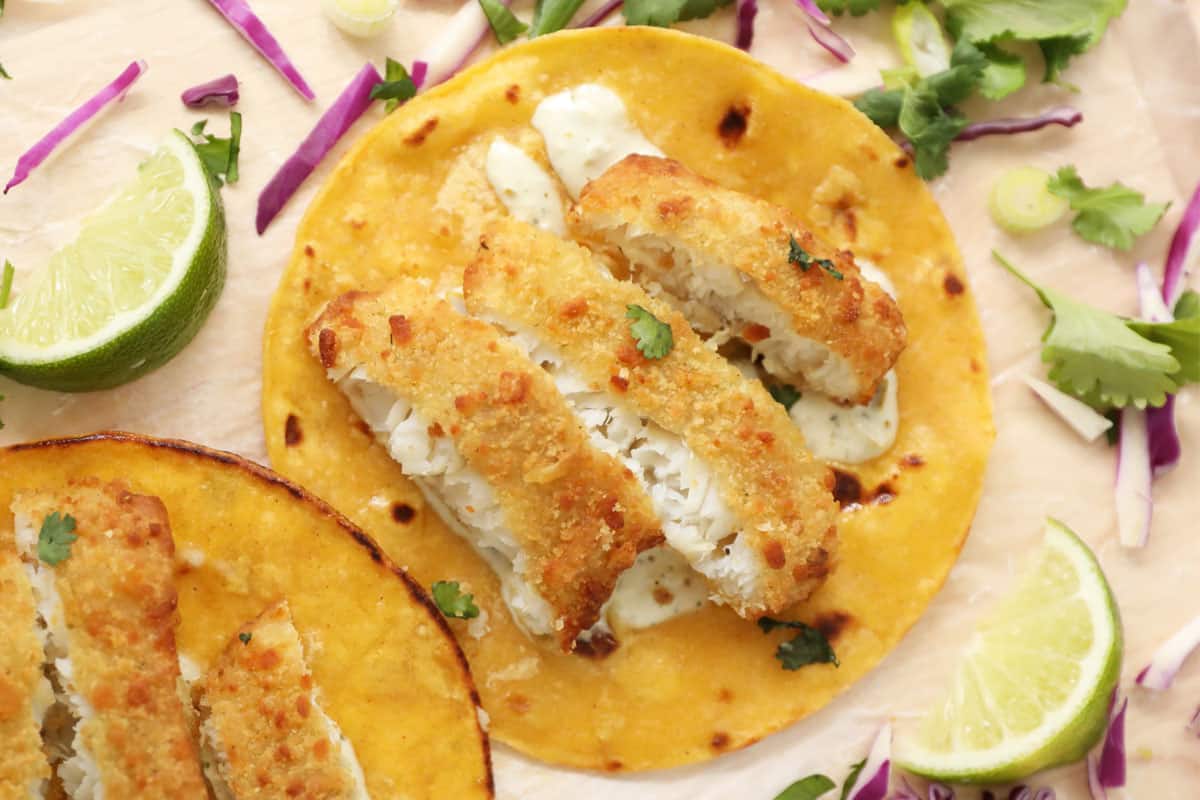 Cod fish taco with breaded fish slices on fried tortilla 
