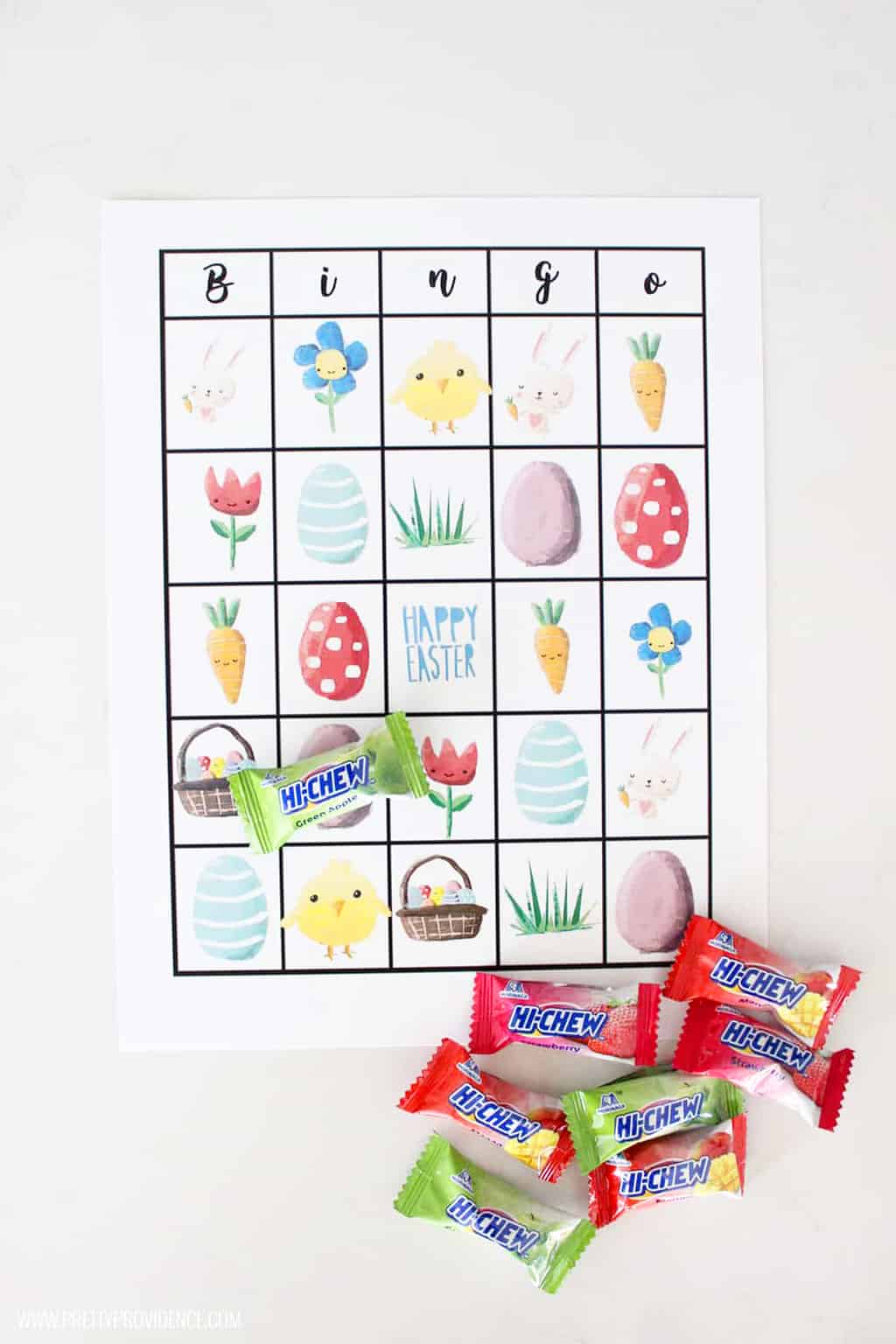 Easter bingo sheet next to a pile of hi chews