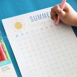A printable summer reading chart with a young girls hand filling in the bubbles.