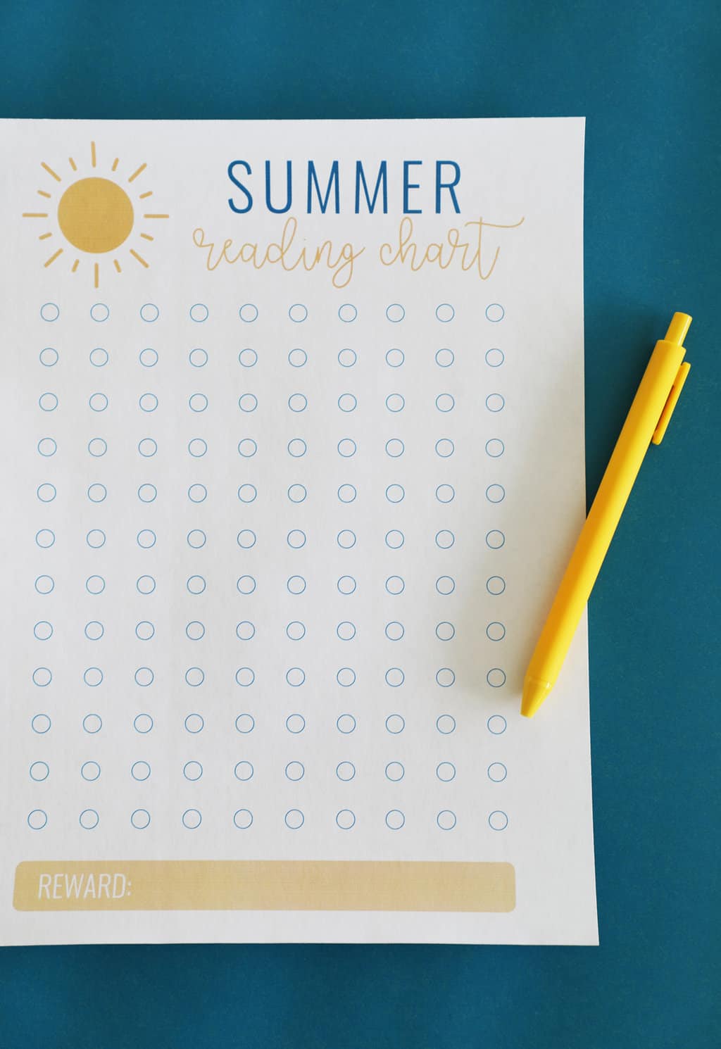 A free printable summer reading chart for kids next to a yellow pen against a blue background.