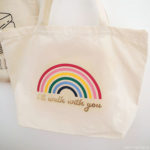 DIY tote bag canvas with a rainbow and the words 'I'll walk with you' in gold iron-on vinyl