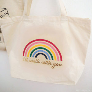 DIY tote bag canvas with a rainbow and the words 'I'll walk with you' in gold iron-on vinyl