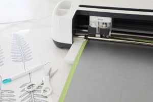 Cricut Maker cutting ferns out of silver removable vinyl