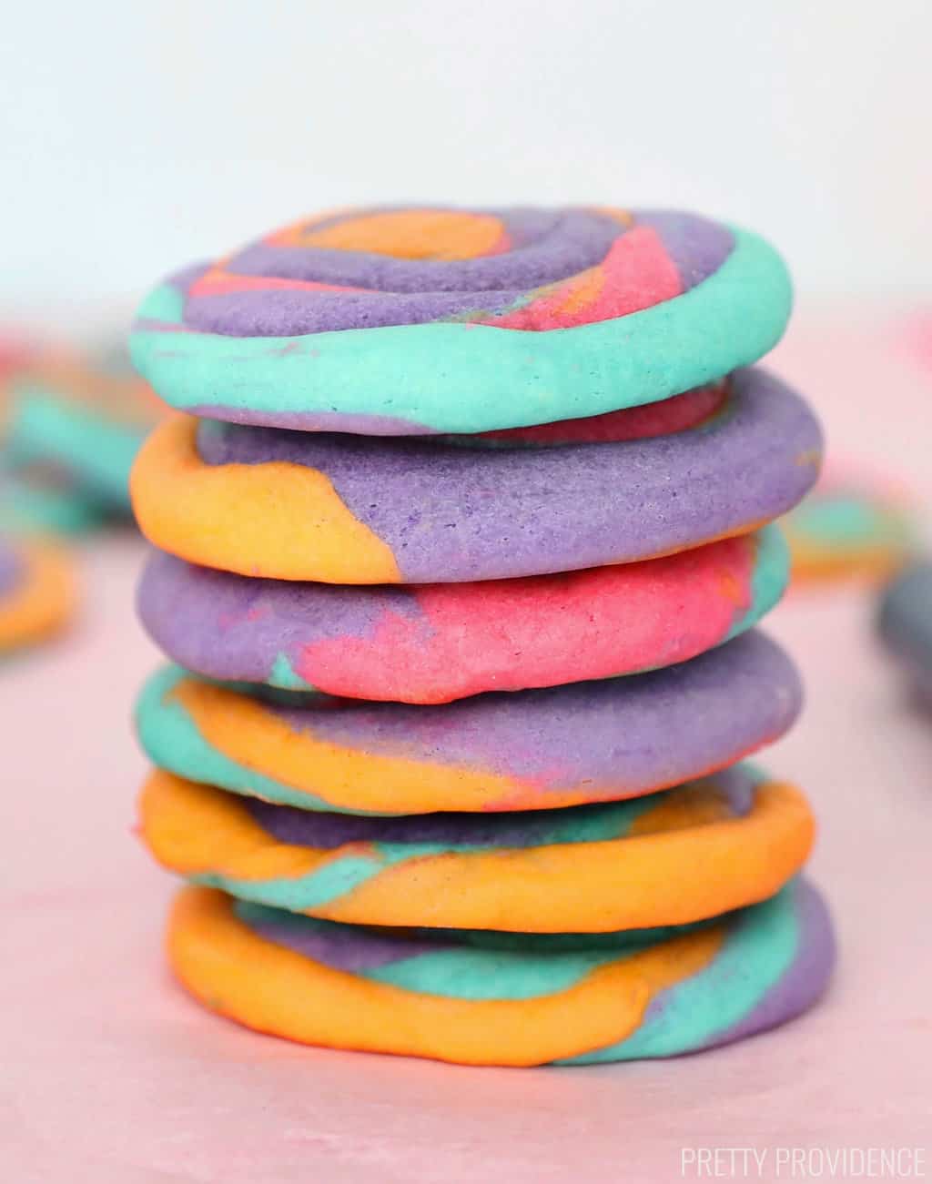 Tie dye cookies orange, purple, pink and turquoise swirls, stacked 
