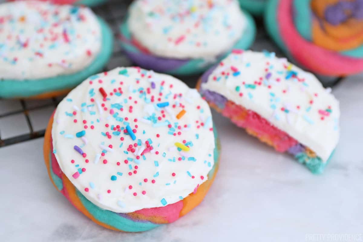 Neon tie dye sugar cookies with white frosting and bright colored sprinkles