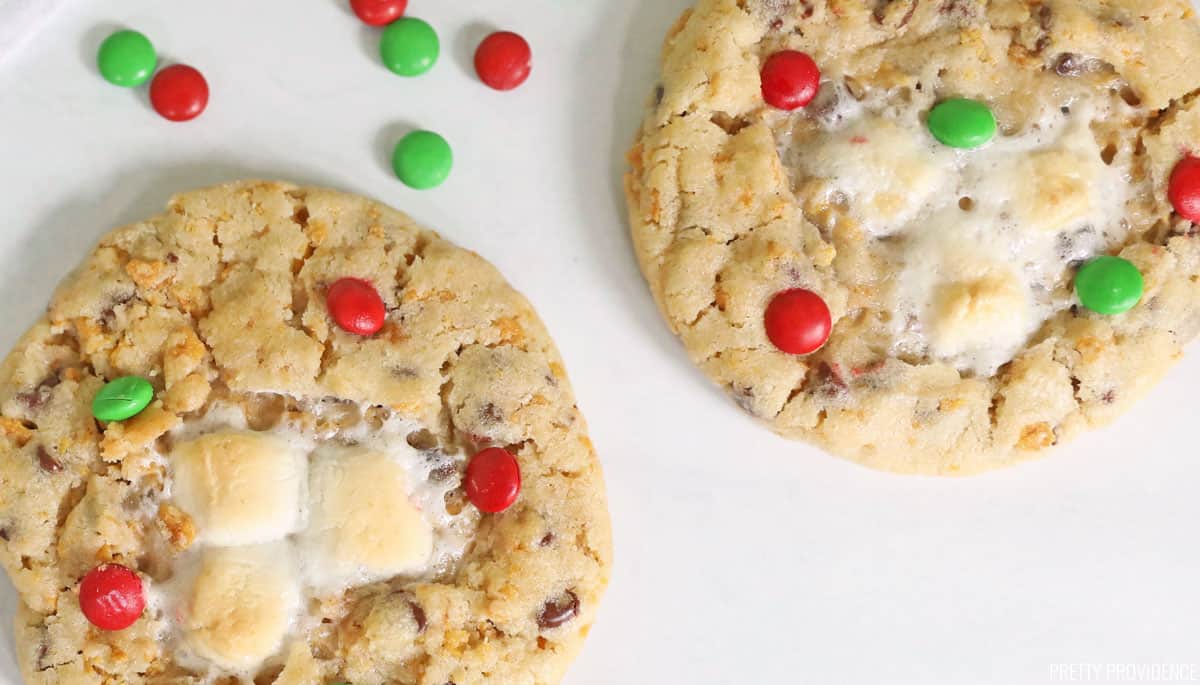 two Christmas m&m cookies with marshmallows and red and green m&ms.