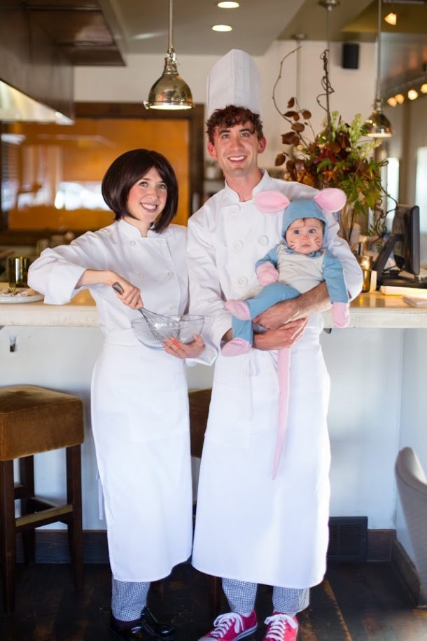 A woman and man dressed as chefs and their baby in a Ratatouille costume.
