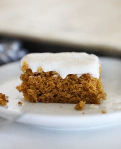 a square of pumpkin sheet cake in front of the pan