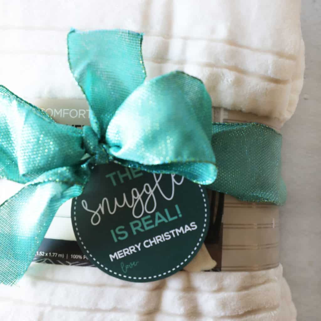 close up of a cream colored blanket with a gift tag