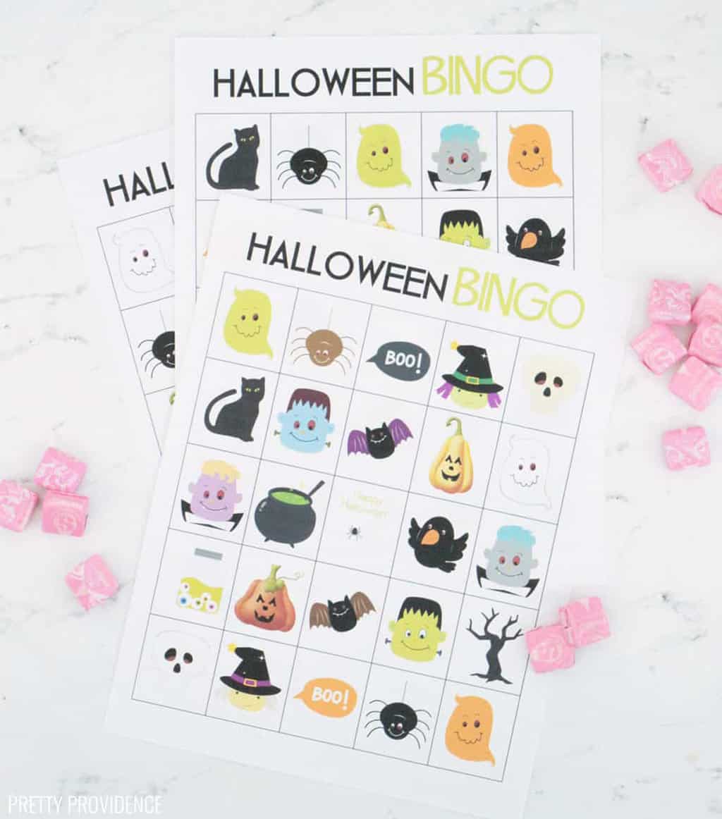 Bingo halloween cards in a mixed snack by scattered pink starbursts. 