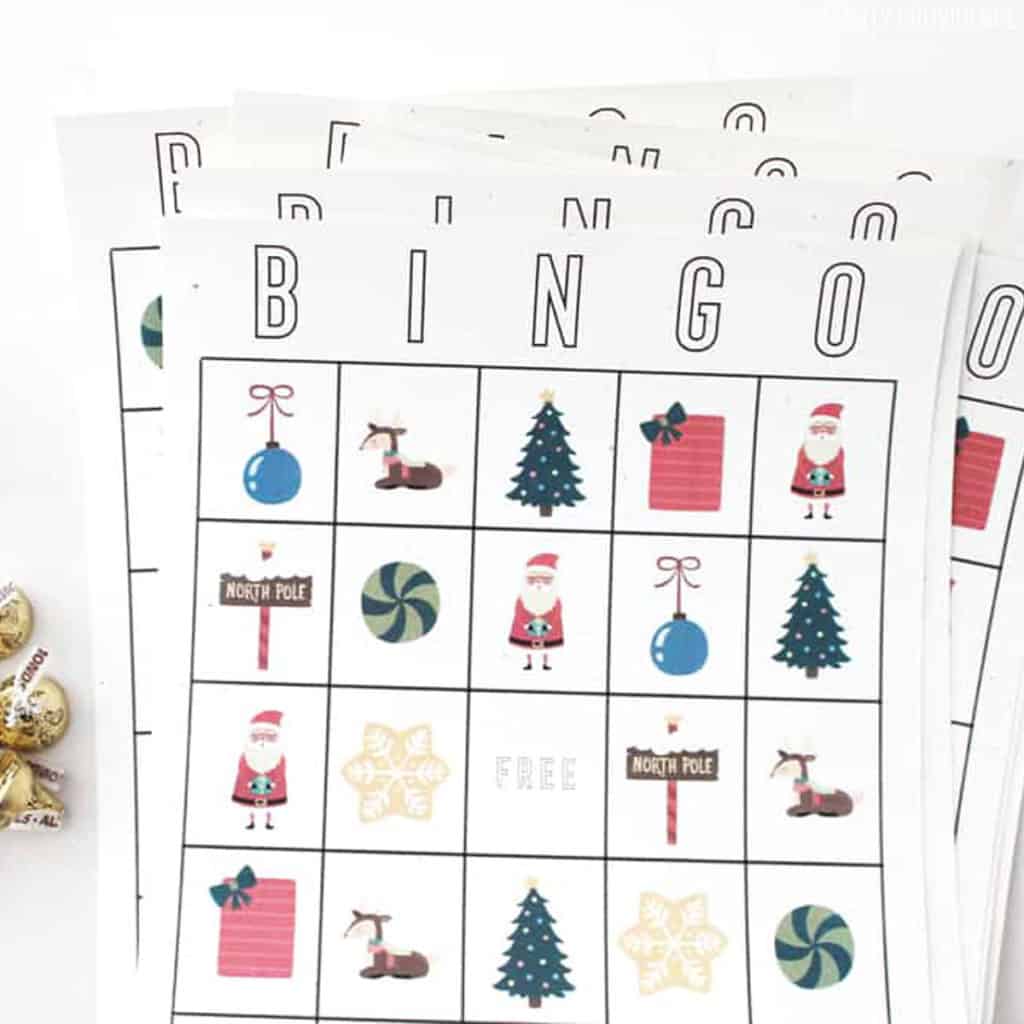Christmas bingo cards with hershey kisses next to them