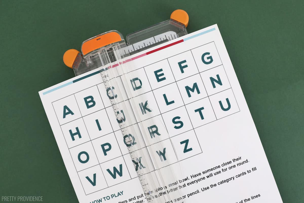 alphabet letters being cut with a fiskars paper cutter.