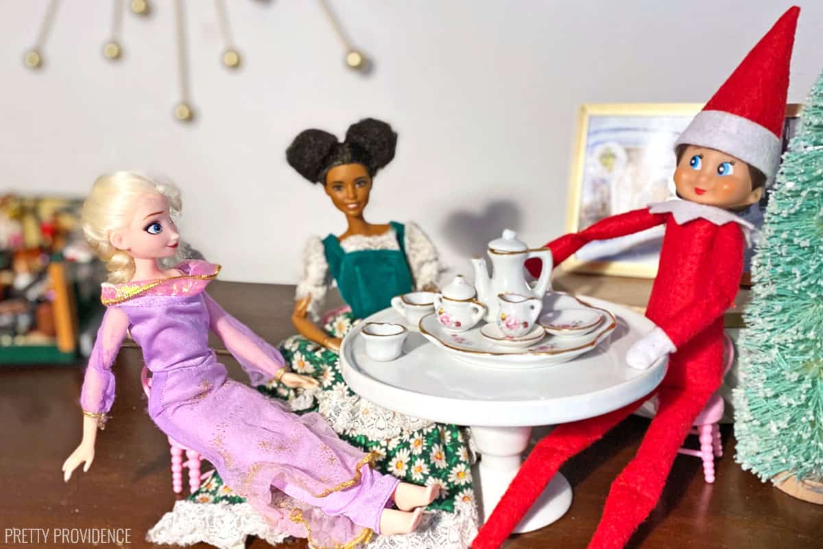 Elf on the Shelf having a tea party with barbies.