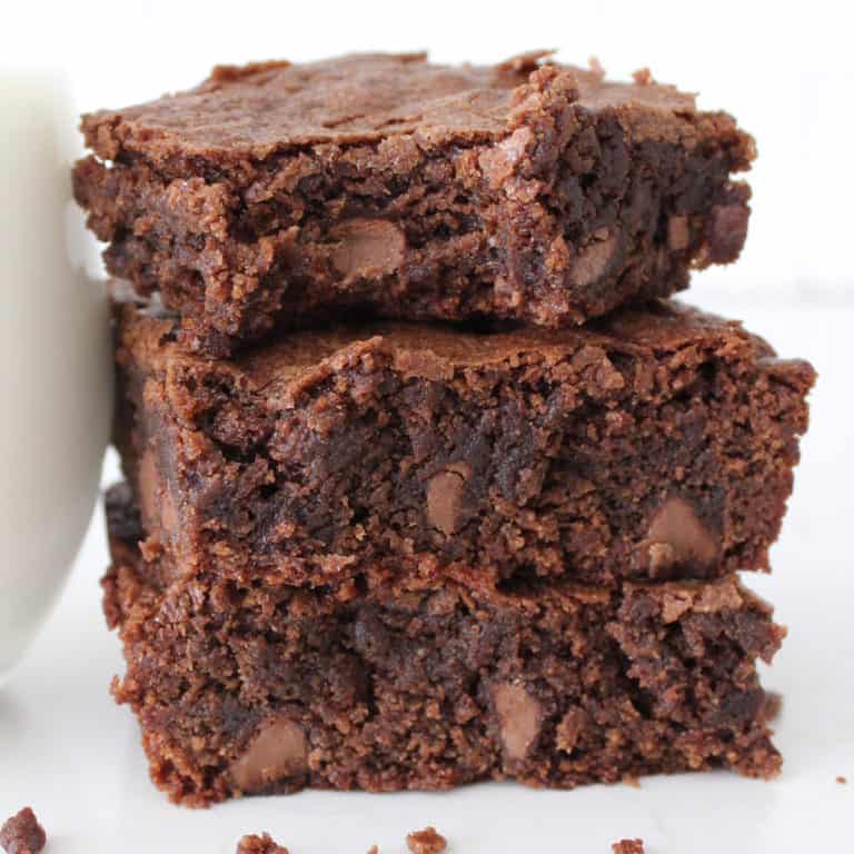 Three stacked homemade brownies up close.