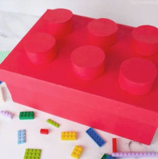 Shoebox covered in red paper and decorated to look like a Lego for a Valentine's box.
