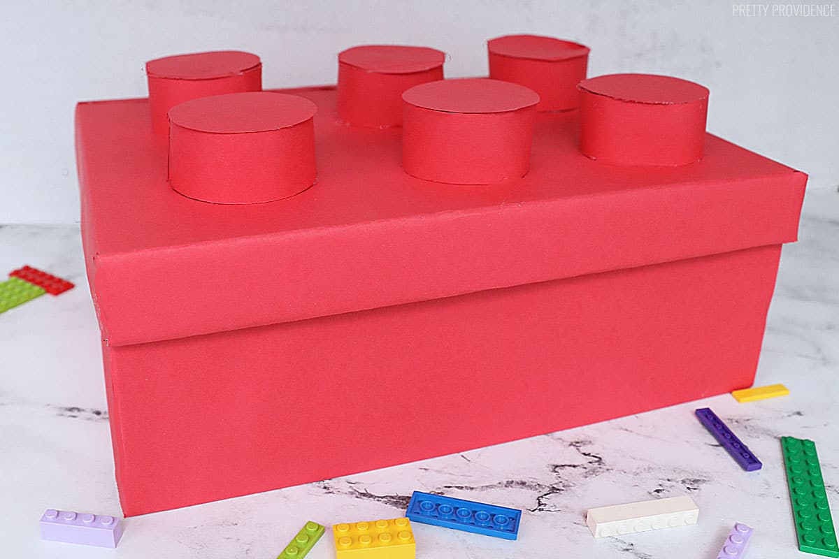 Red Lego Valentines box for kids on a marble surface.