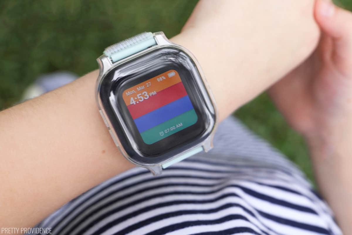 Gabb watch screen with multicolor stripes on a child's wrist.