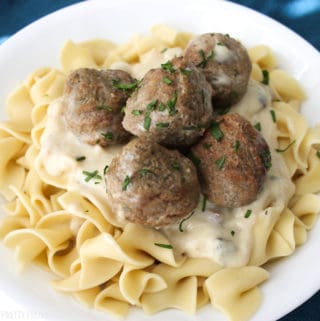 Meatball Stroganoff over egg noodles on a white plate