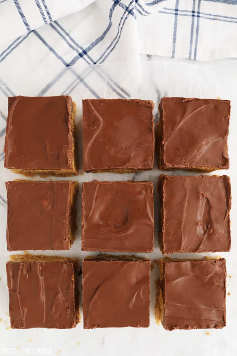Chex scotcheroo bars cut into squares on wax paper.
