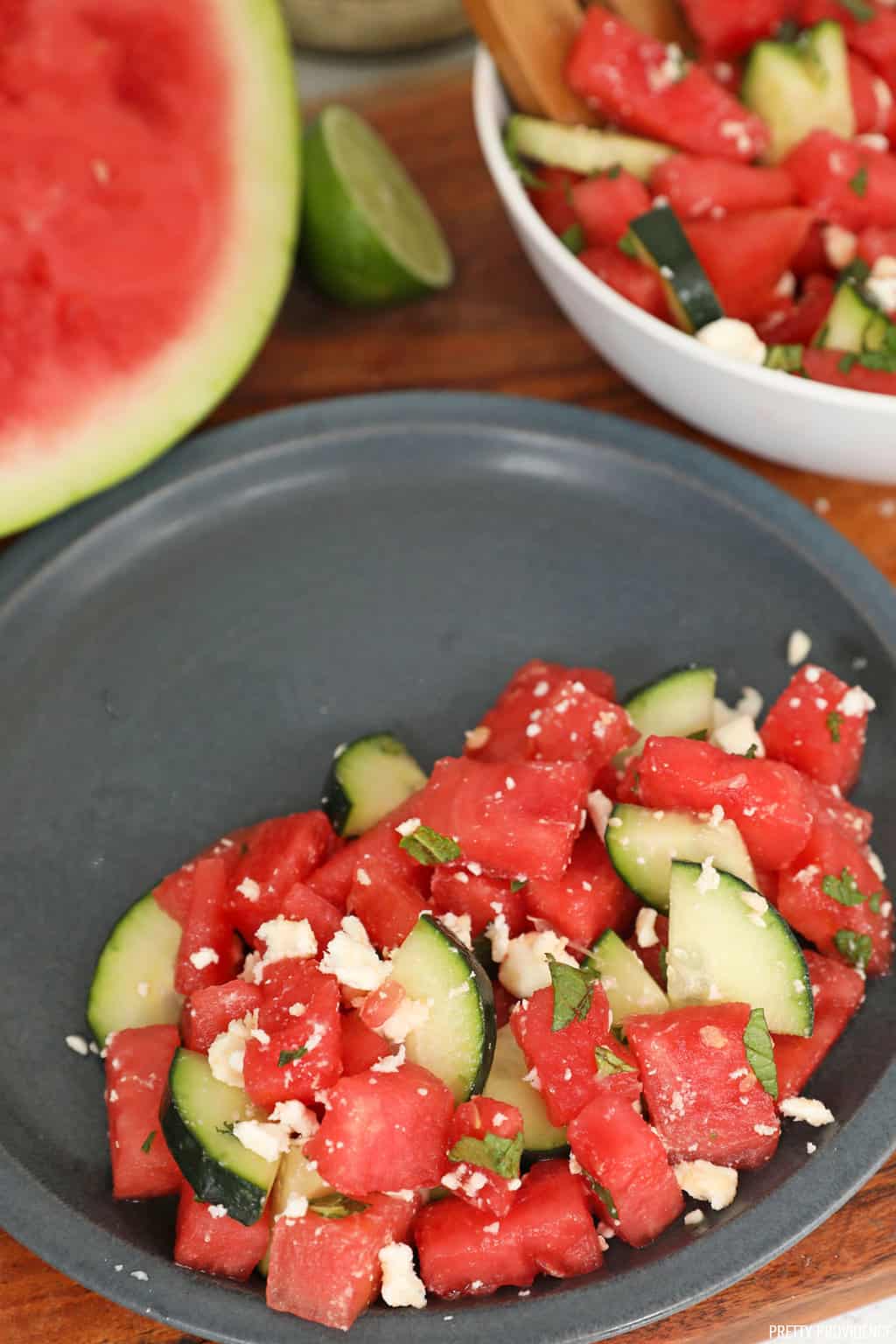 Watermelon feta salad with cucumber and mint on a slate colored plate.