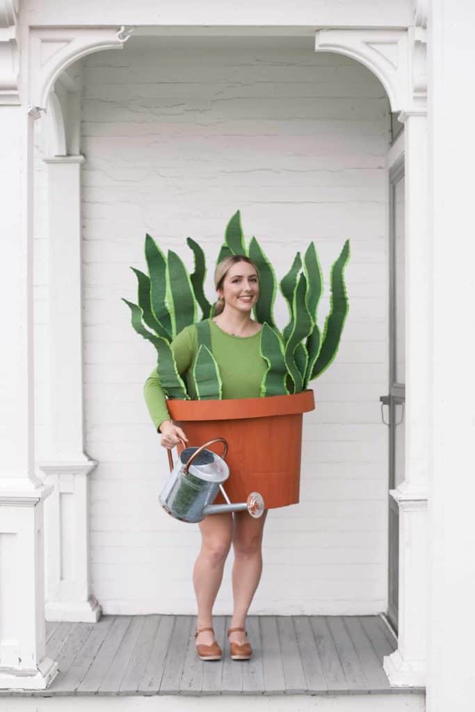 Woman wearing a Snake Plant Costume on a white porch.