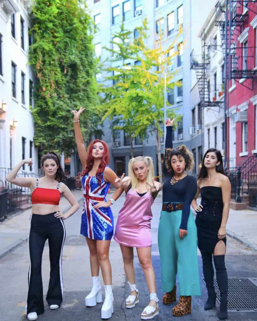 Five women dressed as the Spice Girls in the street for Halloween.