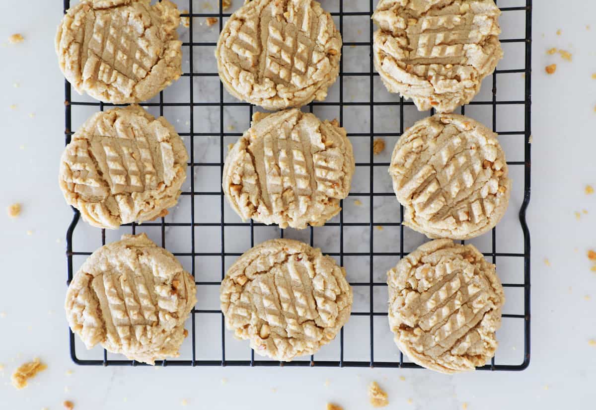 Bird's eye view of old fashioned peanut butter cookies on a black cooling rack.