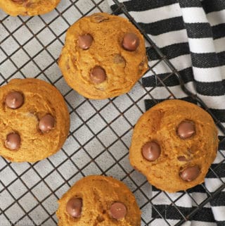 chocolate chip pumpkin cookies on a cooling rack.