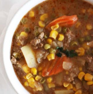 Close-up photo of easy beef stew with vegetables in a white bowl.