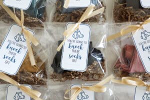 A row of socks in cute baggies ready to gift.