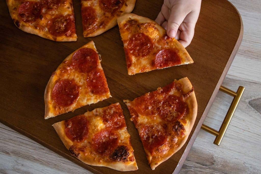 A bird's eye view of a personal pizza made using Rhodes roll dough.