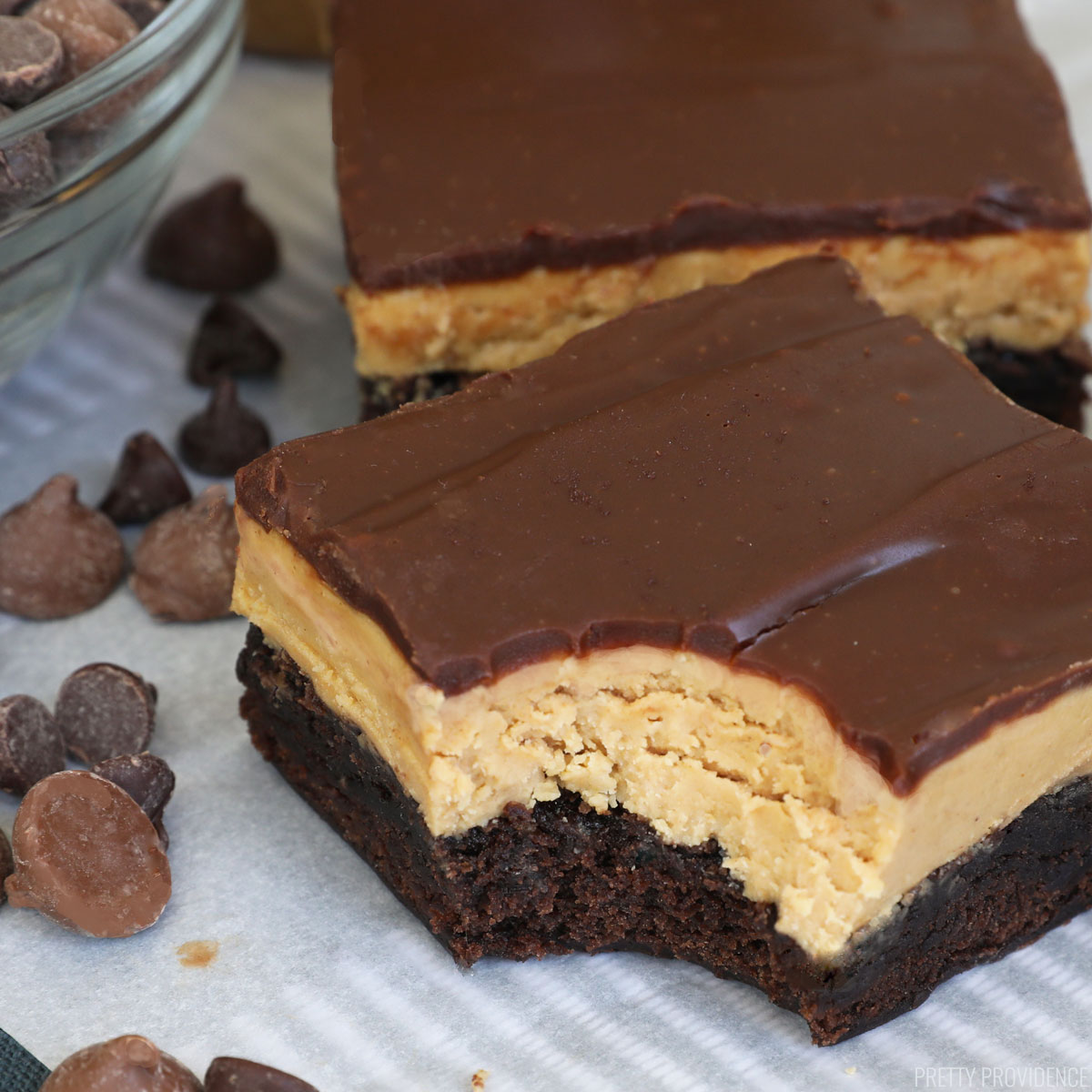 Brownies with peanut butter layer and chocolate ganache on top.