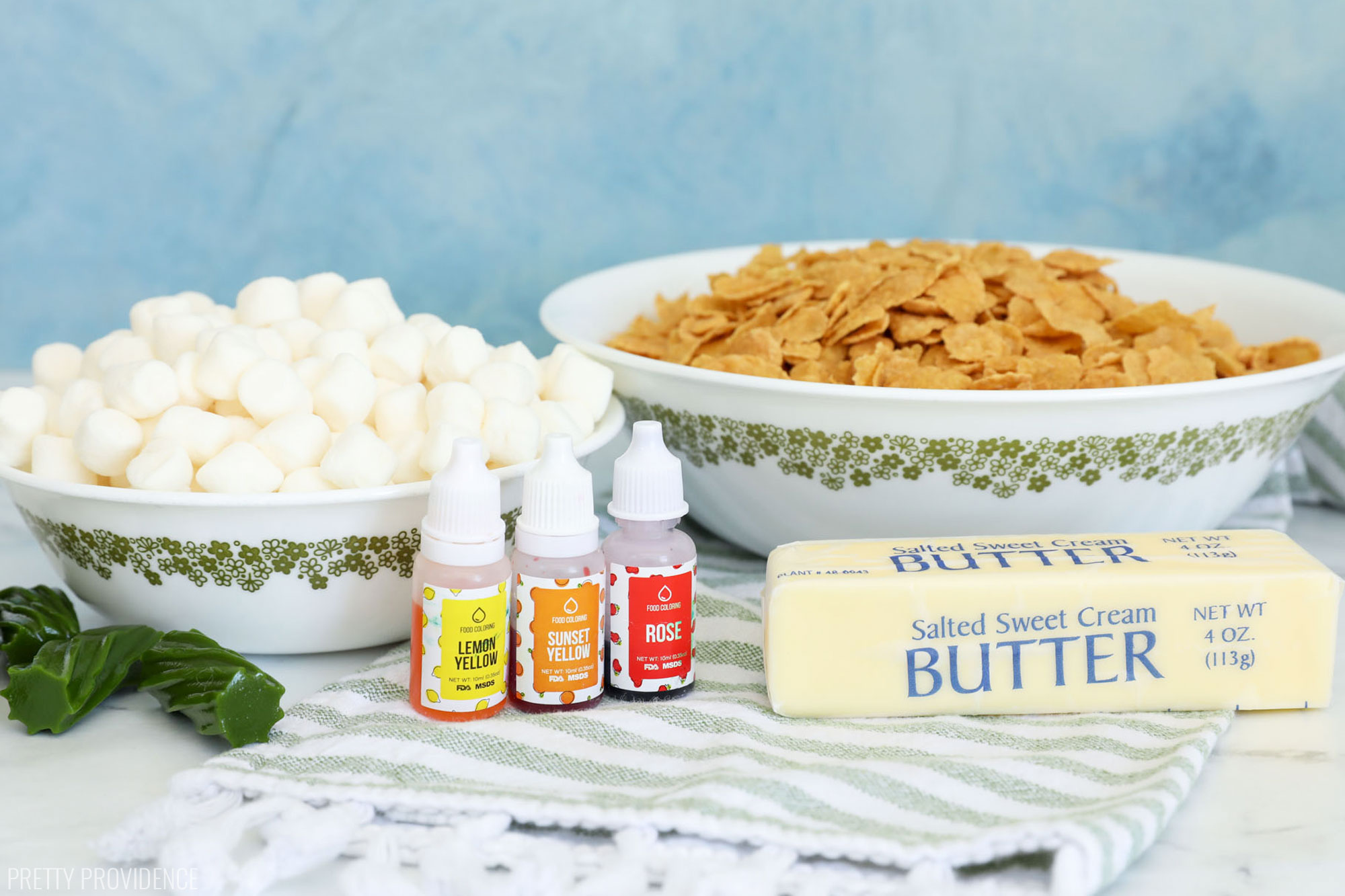 ingredients for corn flake marshmallow treats - mini marshmallows, corn flakes, food coloring, butter, green licorice.