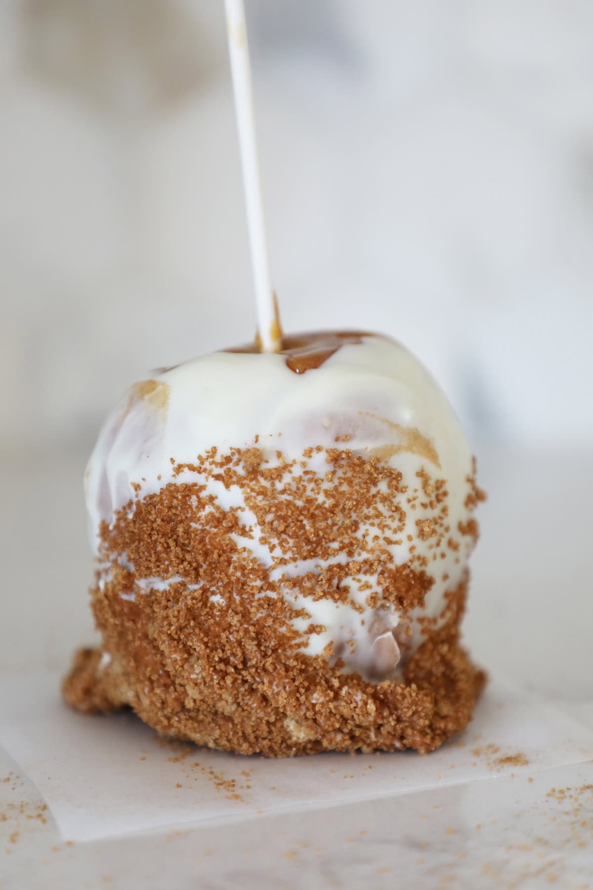 An apple pie flavored gourmet caramel apple with white chocolate. 