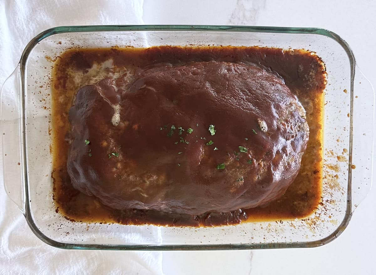 Bird's eye view of homemade meatloaf in a 9x13 glass dish. 