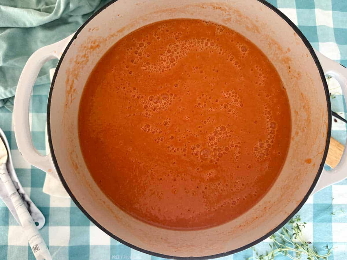 Tomato and white bean soup in a large cast-iron pot. 