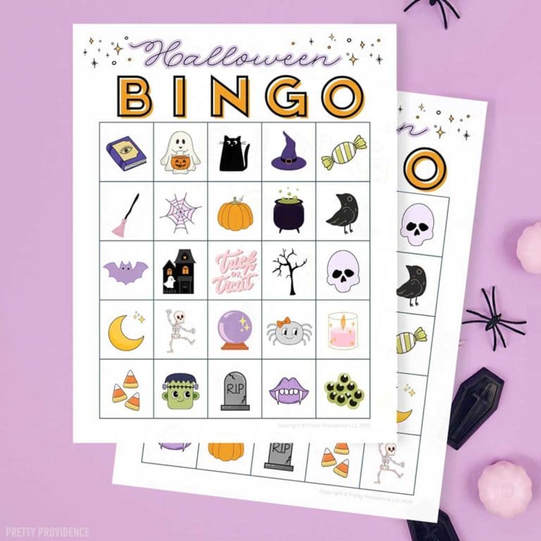 Free printable Halloween Bingo cards with traditional Halloween images like black cat, pumpkin, bat, spider, etc. Papers rest on a purple background.