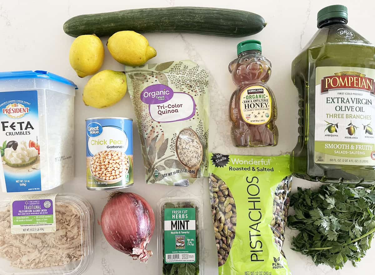 All the ingredients needed to make the viral Jennifer Aniston salad recipe laid out on a white countertop.