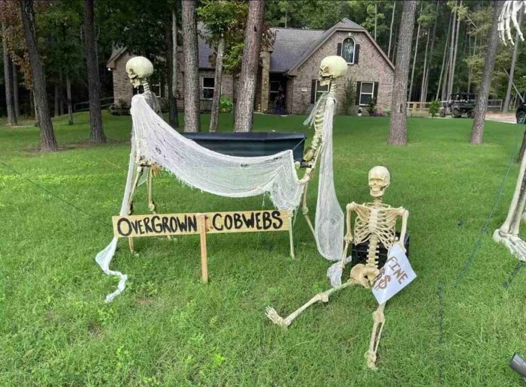 skeletons with HOA fines on a front lawn.