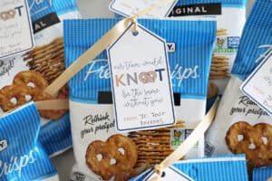 A bunch of individual pretzel bags with printable tags tied on for team gifts.