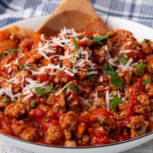 Turkey bolognese sauce with a rich, red sauce color, close-up with fresh parmesan on top.