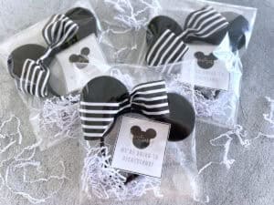 Three bags of Disney ears and printable tags announcing Disney trips.